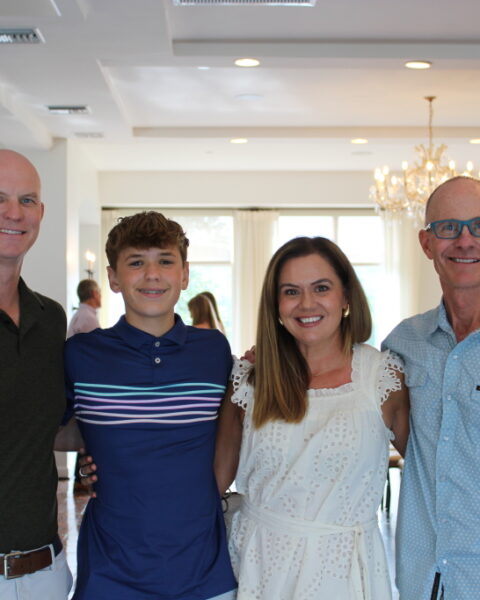 Hayes Newberry with his parents, Kelley and Joe and Coach Trey