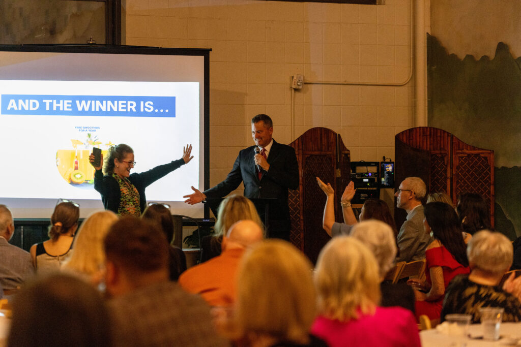 Raffle winner Samantha Young, emcee Bob Ballou