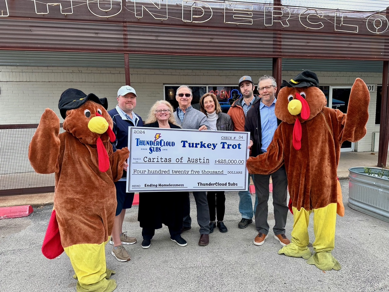 Paul and Patty Sughrue, Mike and Jeannie Haggerty, Ben Haggerty, and David Cohen of ThunderCloud with Trot mascots Andrea Linkenhoger of ThunderCloud and Israel Pena of Caritas