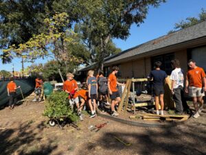 Gabe Fowler’s work team repairing and staining damaged fencing at the Helping Hand Home