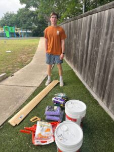 Dash Wilcox preparing for the repair of several hundred feet of weathered and damaged fencing at the Helping Hand Home