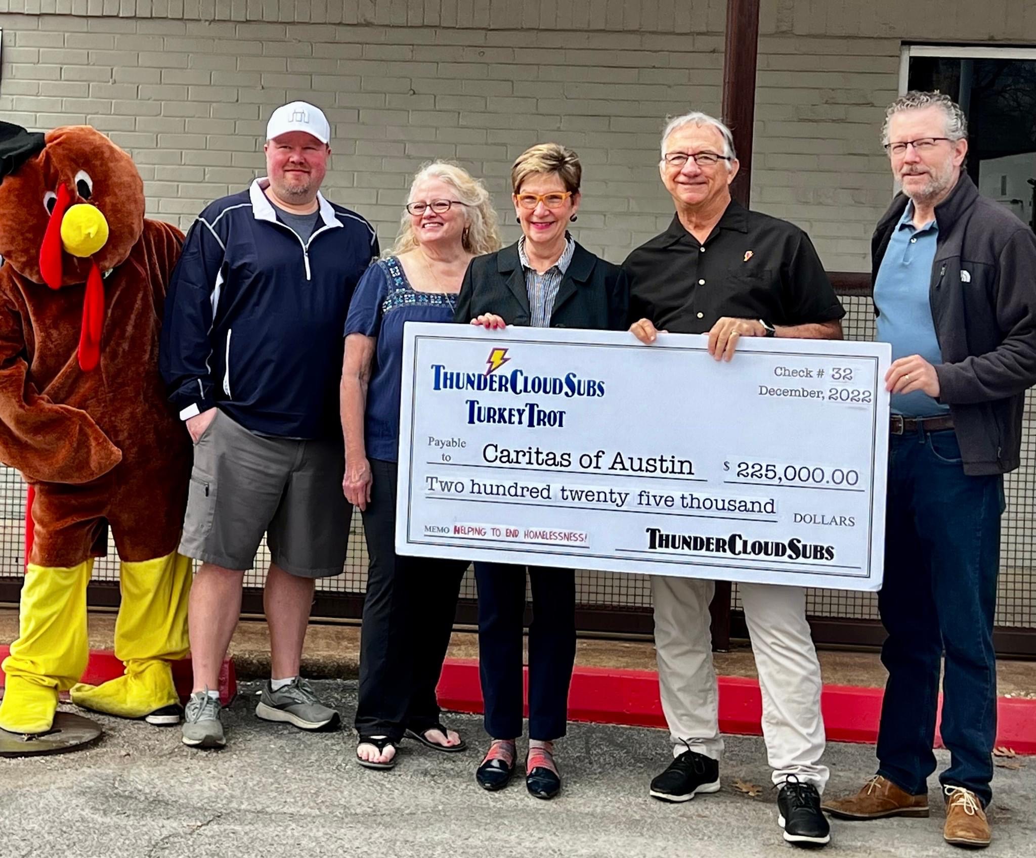 ThunderCloud Trot mascot Rachel Walley, ThunderCloud co-owners Paul and Patty Sughrue, Caritas CEO Jo Kathryn Quinn, Turkey Trot director Mike Haggerty, and ThunderCloud director of development David Cohen